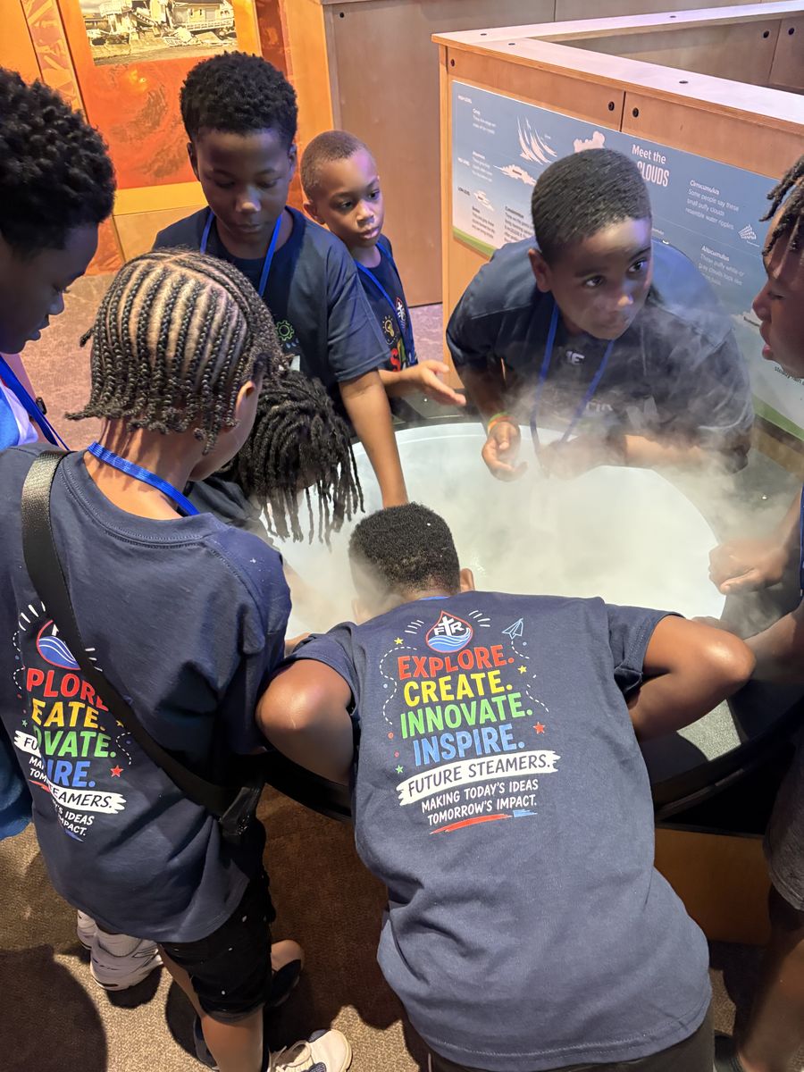 STEAM campers crowding around a tub of dry-ice fog